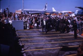 Image of crowds and members of the press at Love Field