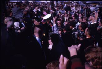 Image of President and Jacqueline Kennedy greeting crowds at Love Field