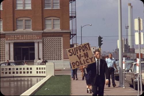 Image of protester in front of Texas School Book Depository