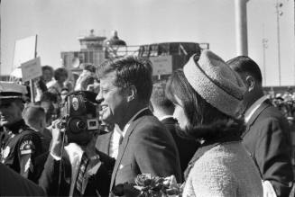 Image of the Kennedys walking toward the crowd at Love Field