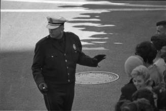 Image of a police officer directing the crowd on Main Street