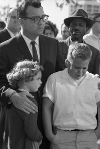 Image of man and children reacting to news of President Kennedy's death