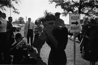 Image of woman outside Parkland reacting to news of President Kennedy's death