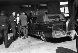 Image of Secret Service agents beside limousine at Parkland Hospital