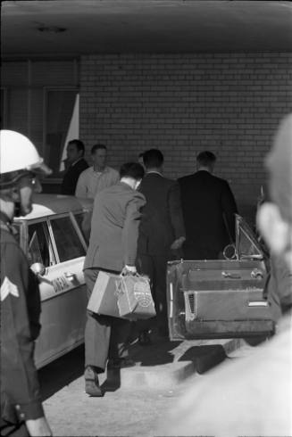 Image of Assistant Press Secretary Malcolm Kilduff entering Parkland Hospital