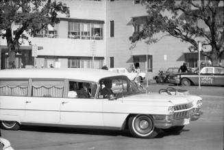 Image of the hearse leaving Parkland Hospital for Love Field