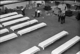 Image of banquet tables being set up at the Dallas Trade Mart