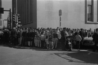 Image of a crowd gathered at Elm and Houston streets on November 22, 1963