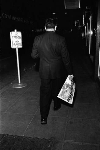 Image of a man in downtown Dallas on the evening of November 22, 1963