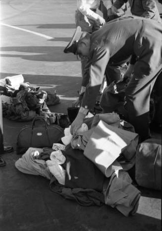 Image of a pile of searched luggage on the tarmac at Love Field