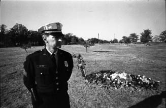 Image of a Fort Worth Police officer guarding Lee Harvey Oswald's grave