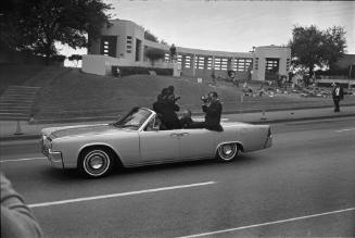 Image of convertible with Secret Service agents reenacting the assassination