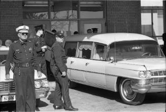 Image of hearse at Parkland Hospital with casket for President Kennedy