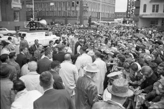 Image of President Kennedy with crowds outside the Hotel Texas