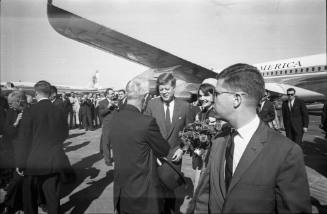 Image of the Kennedys greeting a man at Love Field