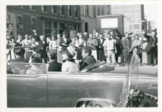 Black and white photograph of the Kennedys in the motorcade on Main Street