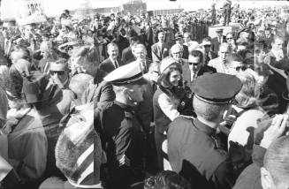 Images of Mrs. Kennedy greeting the crowd at Love Field