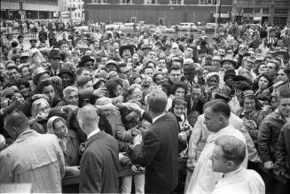 Image of President Kennedy shaking hands outside the Hotel Texas