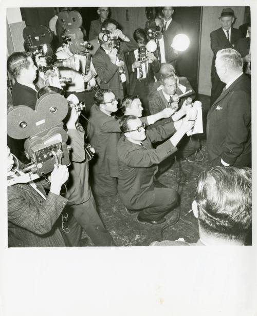 Photo of a press conference interviewing an unknown man during the Ruby trial