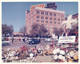 Photo of Dealey Plaza with flowers the morning after the assassination
