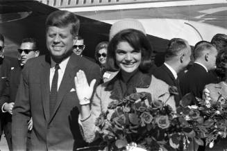 Image of President and Mrs. Kennedy smiling at Love Field