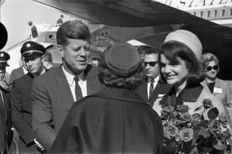 Image of President and Mrs. Kennedy meeting a woman at Love Field