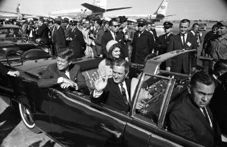Image of the Kennedys and Governor Connally in the limousine at Love Field