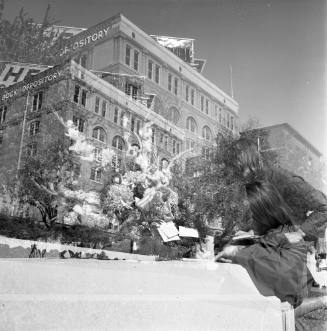 Double-exposed image of a woman in Dealey Plaza