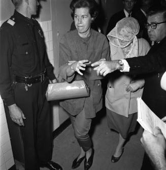 Image of Eva Grant in a crowded hallway at Dallas Police Department Headquarters