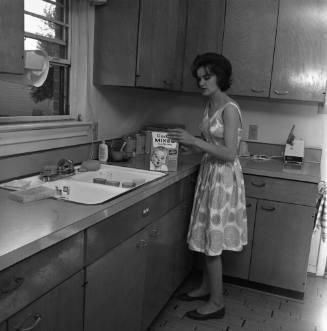 Image of Marina Oswald in the kitchen of her home
