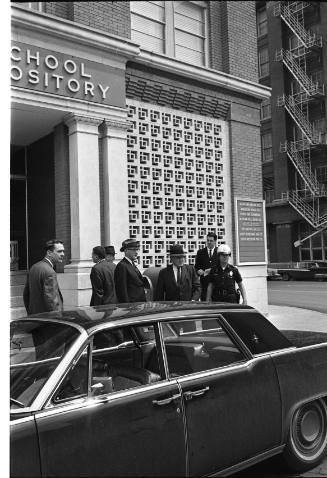 Image of members of the Warren Commission in front of the Book Depository