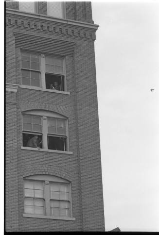 Image of investigators in the southeast corner windows of the Book Depository