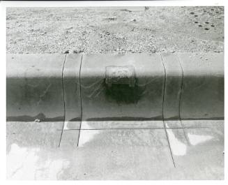 Photograph of a section of curb in Dealey Plaza