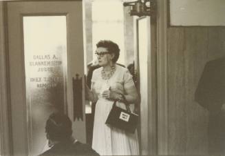 Woman entering courtroom during a hearing about a Dallas civil rights protest