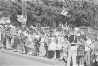 Image of schoolchildren along motorcade route in San Antonio, Texas