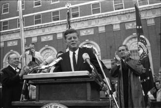 Image of President Kennedy speaking in the Hotel Texas parking lot