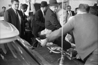 Image of Lee Harvey Oswald on a stretcher outside Parkland Hospital