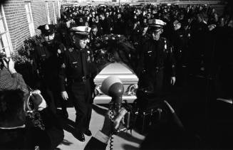 Image of pallbearers carrying the casket at Officer J.D. Tippit's funeral