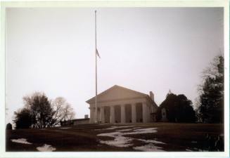 Color photograph of flag at half-staff at Arlington National Cemetery