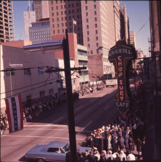 Color image of crowds lining Main Street waiting for the Presidential motorcade