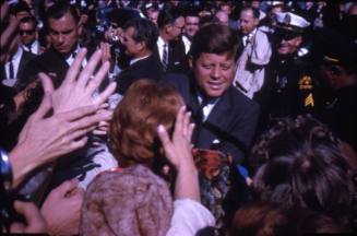 Image of President Kennedy surrounded by crowds at Love Field