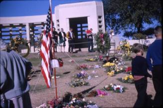Image of flag and flowers in Dealey Plaza after the assassination