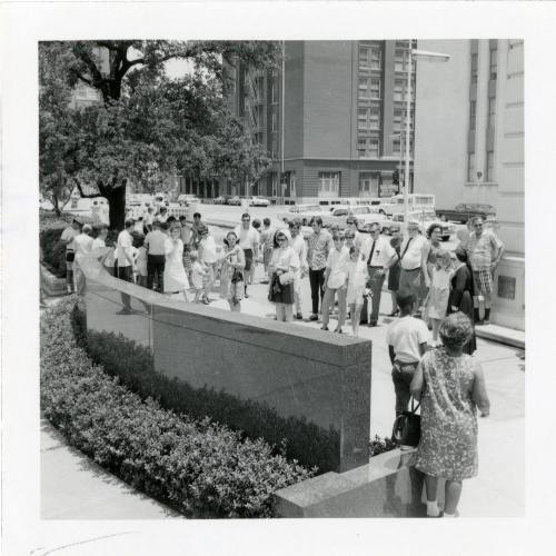 Black and white photograph of crowd in Dealey Plaza