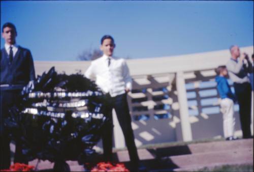 Image of flowers and mourners in Dealey Plaza