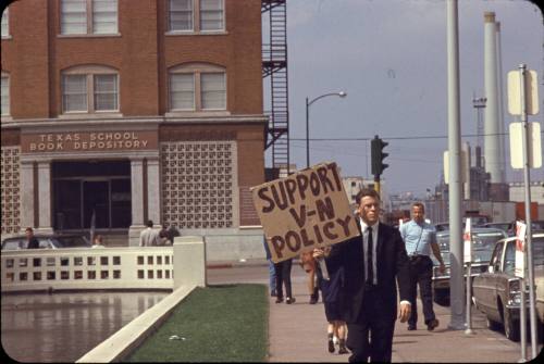Image of protester in front of Texas School Book Depository