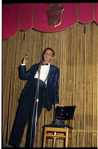 Image of comedian Wally Weston on stage at the Carousel Club