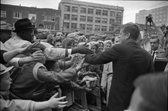 Image of President Kennedy greeting the crowd outside the Hotel Texas