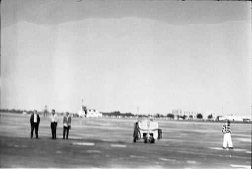 Image of four airport workers on the tarmac at Love Field