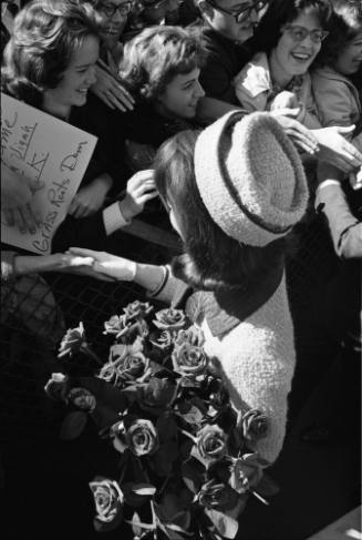 Image of Jacqueline Kennedy greeting the crowd at Love Field