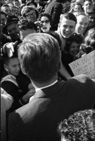 Image of President Kennedy greeting the crowd at Love Field